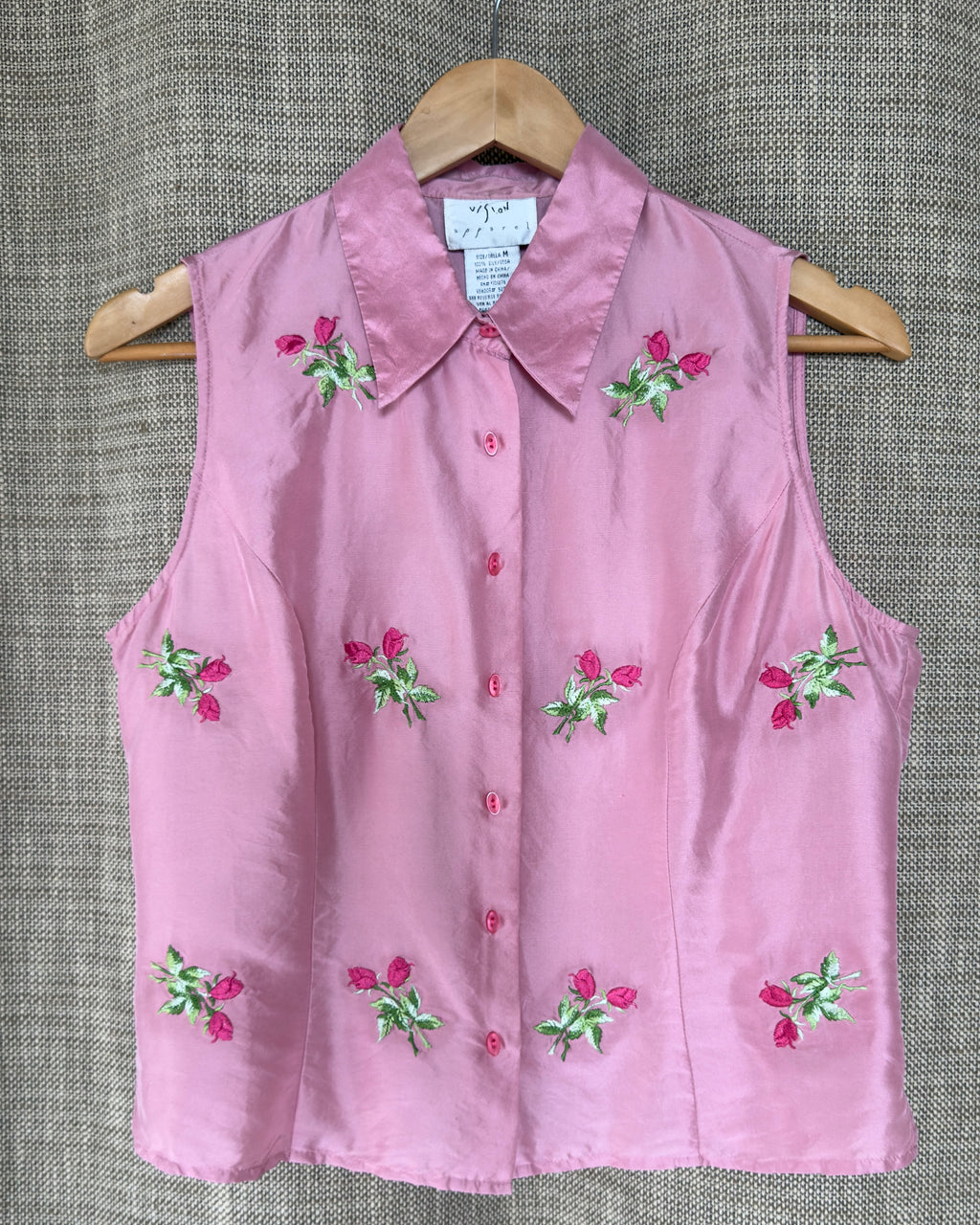 Vision Apparel pink silk top on hanger, front view