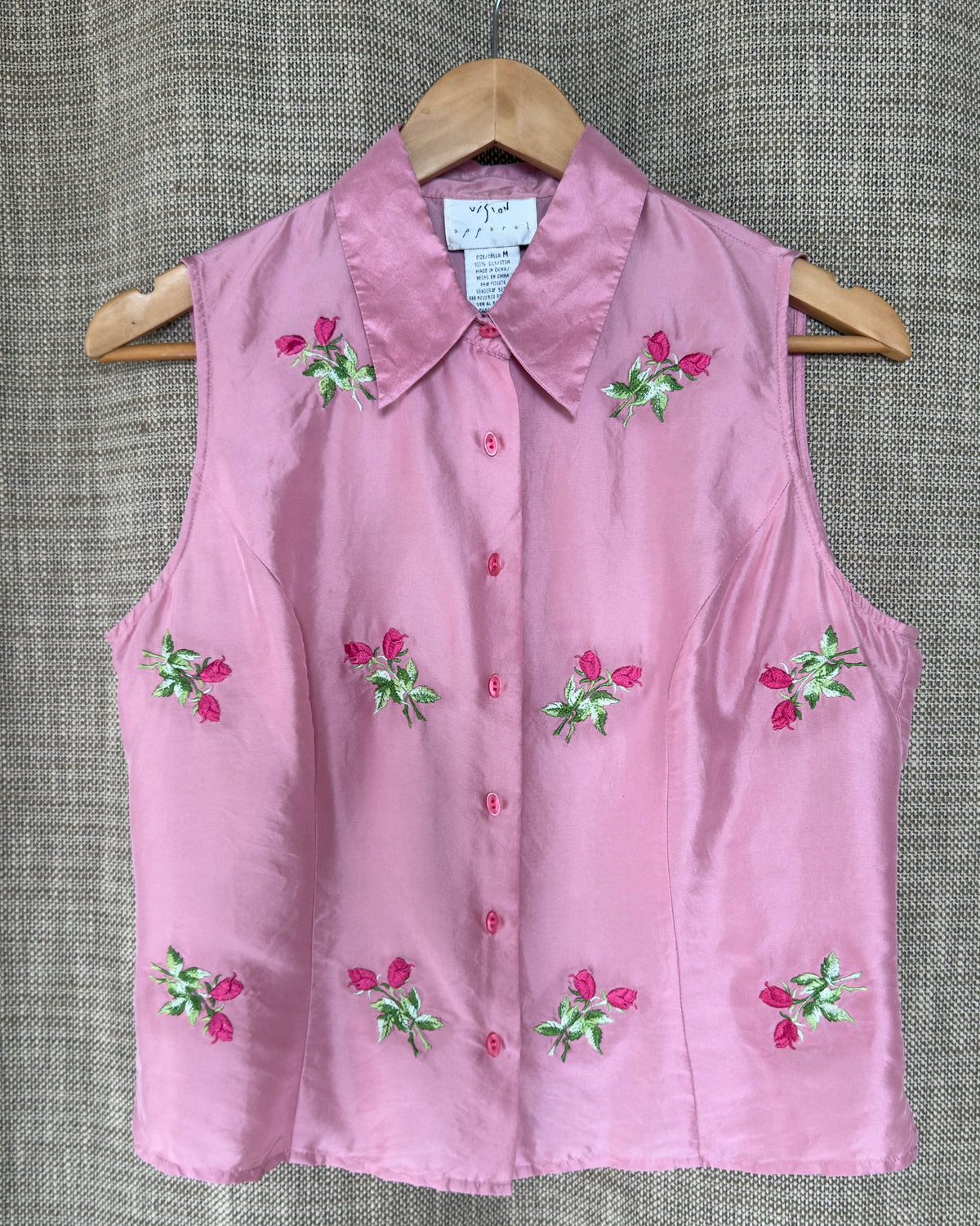 Vision Apparel pink silk top on hanger, front view