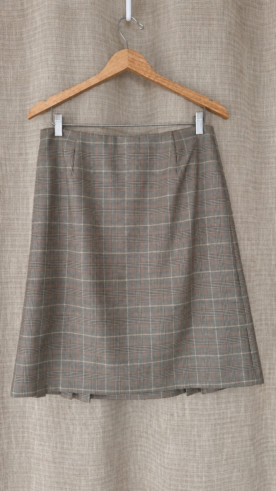 Brooks Brothers tan and brown plaid wool skirt on hanger, back view