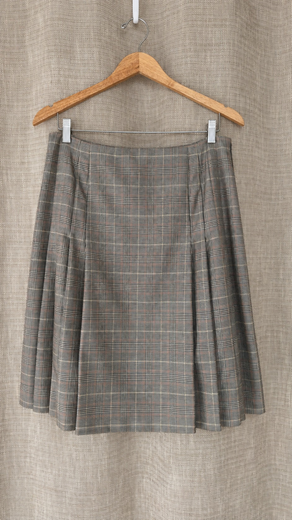 Brooks Brothers tan and brown plaid wool skirt on hanger, front view