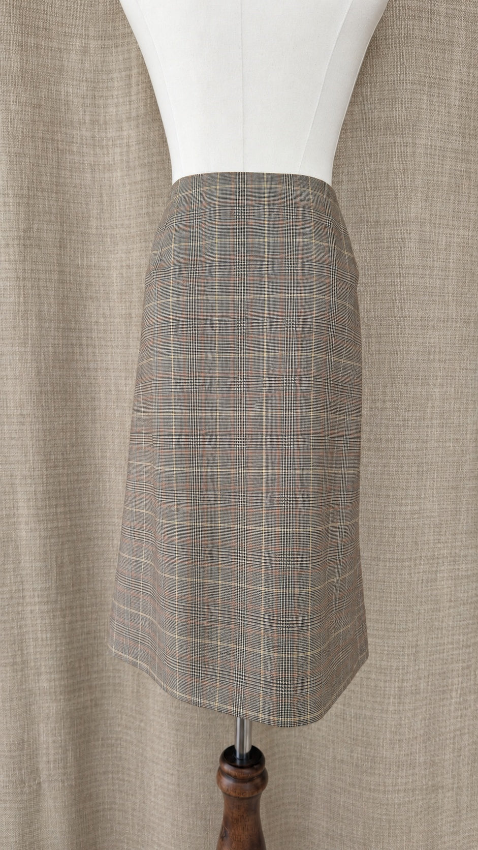 Brooks Brothers tan and brown plaid wool skirt on mannequin, back view