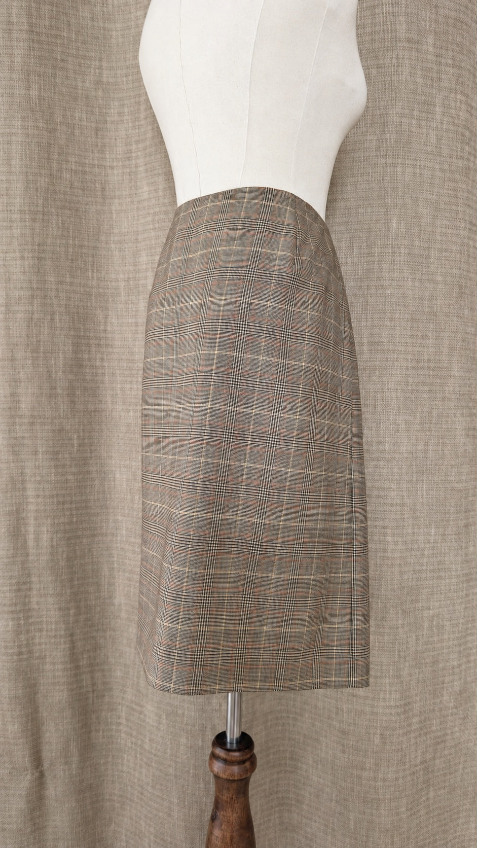 Brooks Brothers tan and brown plaid wool skirt on mannequin, back side view