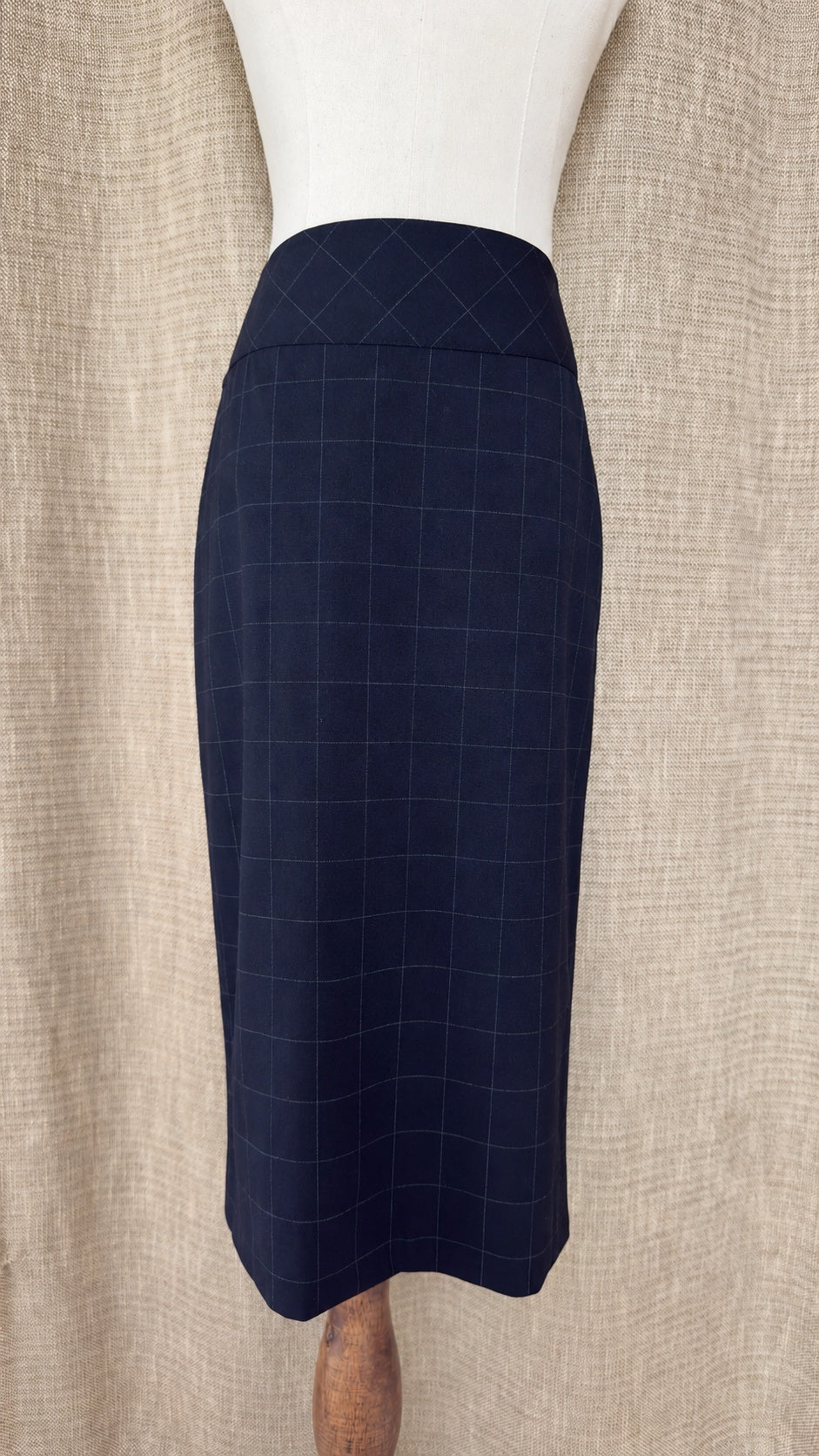 Façonnable dark windowpane wool skirt on mannequin, front view