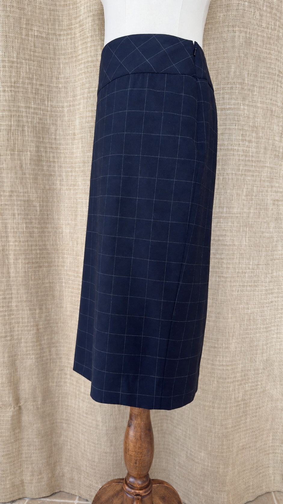 Façonnable dark windowpane wool skirt on mannequin, side view