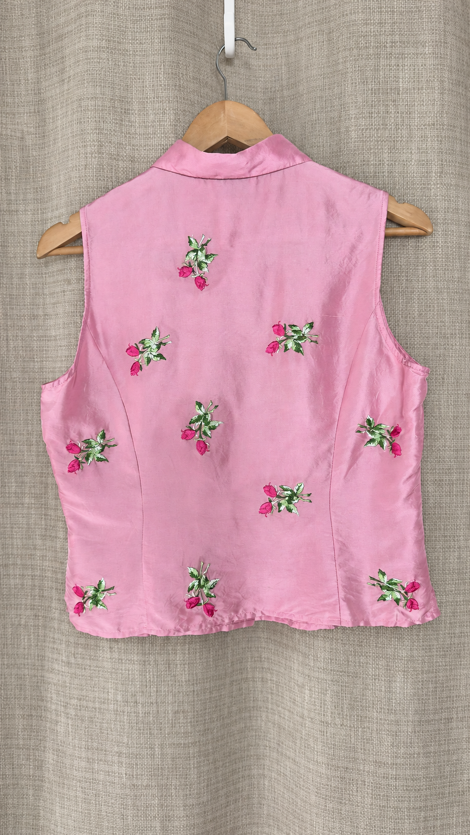 Vision Apparel pink silk top on hanger, back view